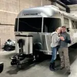 Anne & Bill stand outside in front of their new Airstream