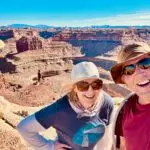 Anne & Bill take a selfie in front of the canyon through which the Colorado River flows, in Canyonlands National Park