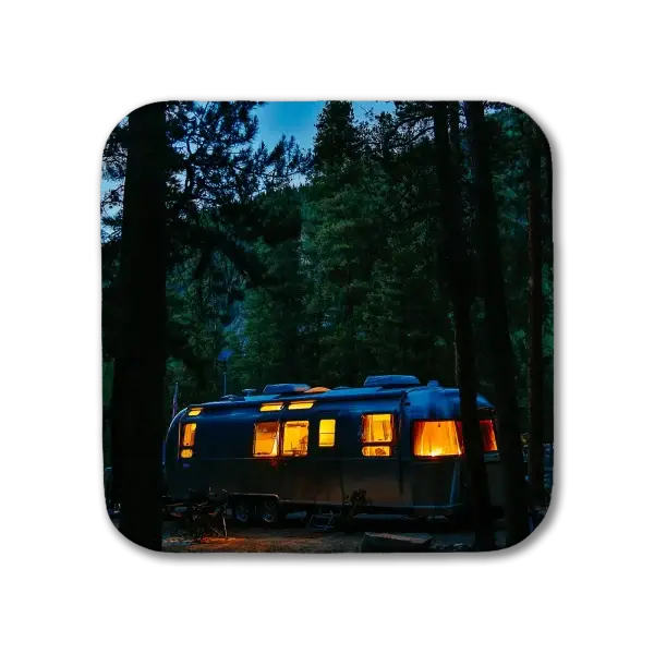 Airstream at dusk amid pine trees in Colorado