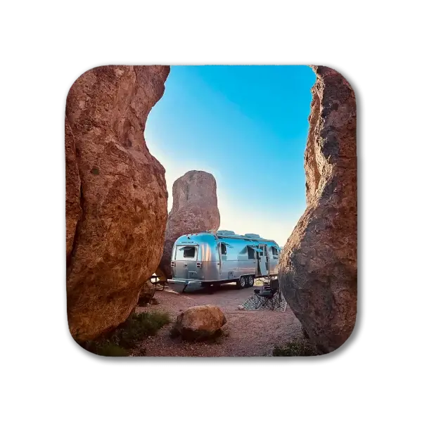 Coaster featuring an Airstream against a backdrop of red rocks in City of Rocks State Park, NM