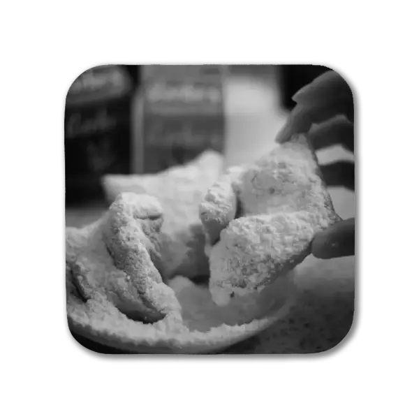 Coaster with a B&W Image in New Orleans' French Quarter of fingers reaching to sugar-covered beignets in Cafe du Monde
