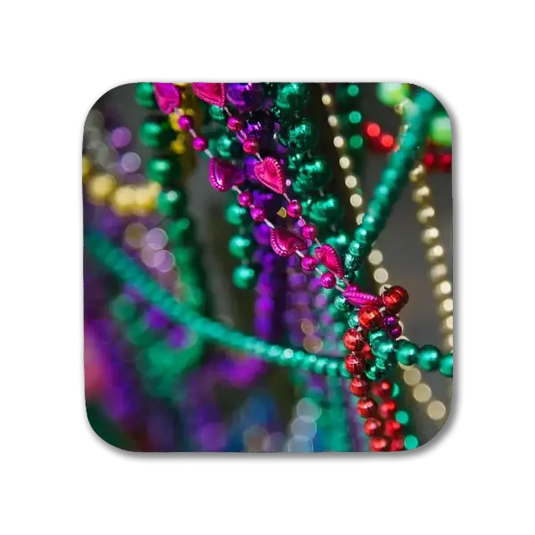 A coaster featuring a New Orleans picture of colorful Mardi Gras beads
