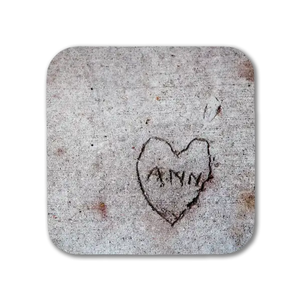 A coaster featuring a New Orleans scene of the name "Ann" written in a heart etched into a sidewalk