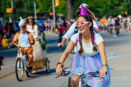 A costumed female rider bikes in the Tour de Fat