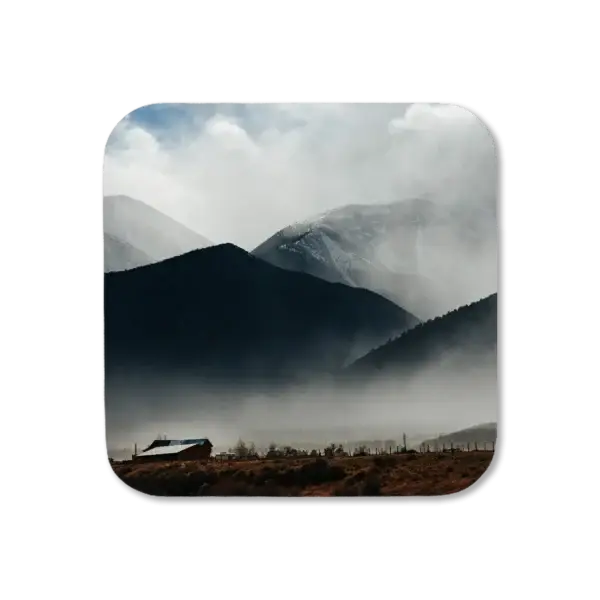 A portion of Mt Princeton is visible through the fog, with a barn backlit against the afternoon light, artwork for a coaster