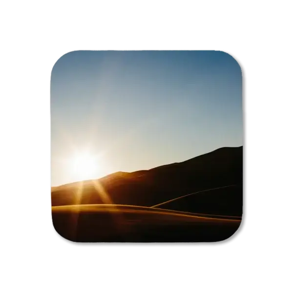The sun sets over rolling dunes at Great Dunes National Park, artwork for a coaster