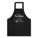 Cooking in a Tiny Kitchen Airstream Apron Black apron with "Cooking in a tiny kitchen since 2021" text in a mid-century modern typeface with Airstream trailer graphic