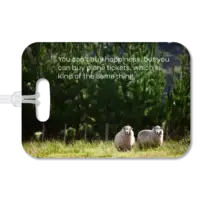 New Zealand luggage tag Premium luggage tag featuring two New Zealand sheep in a grassy field with evergreens in the background. Superimposed text says You can't buy happiness, but you can buy plane tickets, which is kind of the same thing.