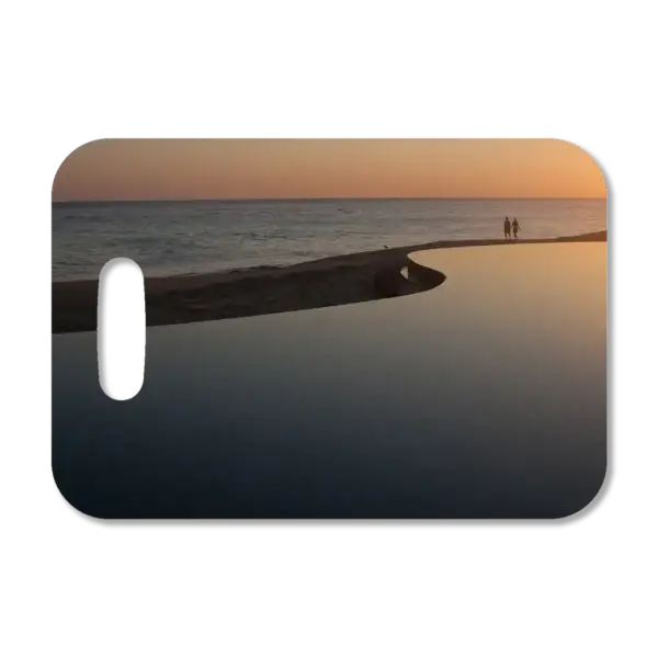 Premium luggage tag featuring a couple walking along a beach at a Mexican resort.