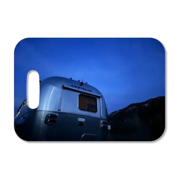 Premium luggage tag featuring an Airstream trailer just after sunset