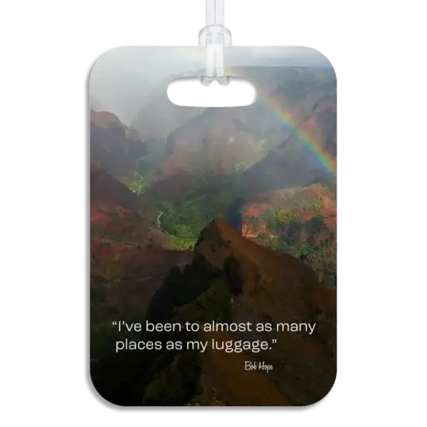 Kauai Luggage Tag Premium luggage tag featuring a Kauai mountainous coastline with a colorful rainbow. Superimposed text says I've been to almost as many places as my luggage, by Bob Hope.