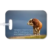 Premium luggage tag featuring a Hereford bull in a New Zealand field. Superimposed quote says, Airplane travel is nature's way of making you look like your passport photo, by Al Gore.