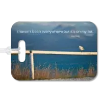 New Zealand Sea Bird Sits on Fence Luggage Tag Premium luggage tag featuring a New Zealand seagull standing along a fence with the ocean in the background. Supimposed quote says I haven't been everywhere but it's on my list, by Susan Sontag.