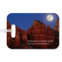 Personalized Photo Luggage Tag Premium luggage tag featuring Sedona red rocks and the full moon rising above, shortly after sunset. Superimposed text says, I followed my heart and it led me to the airport.